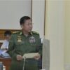 Regime chief Min Aung Hlaing submits his report on emergency rule to the NDSC on Tuesday. (Photo: Cincds)
