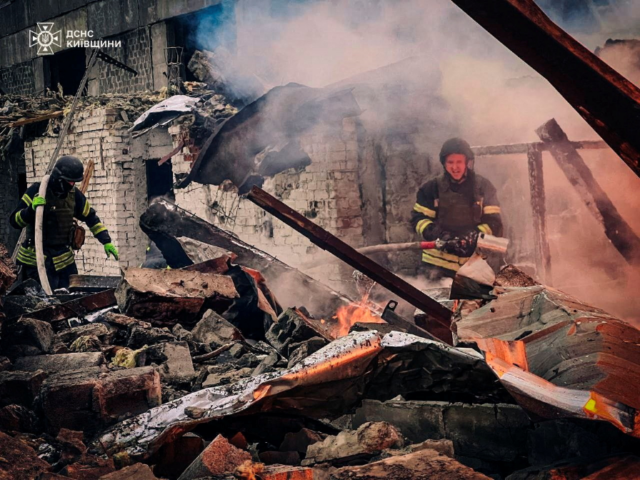 KYIVMISSILE1 Firefighters at work in an area in Ukraine