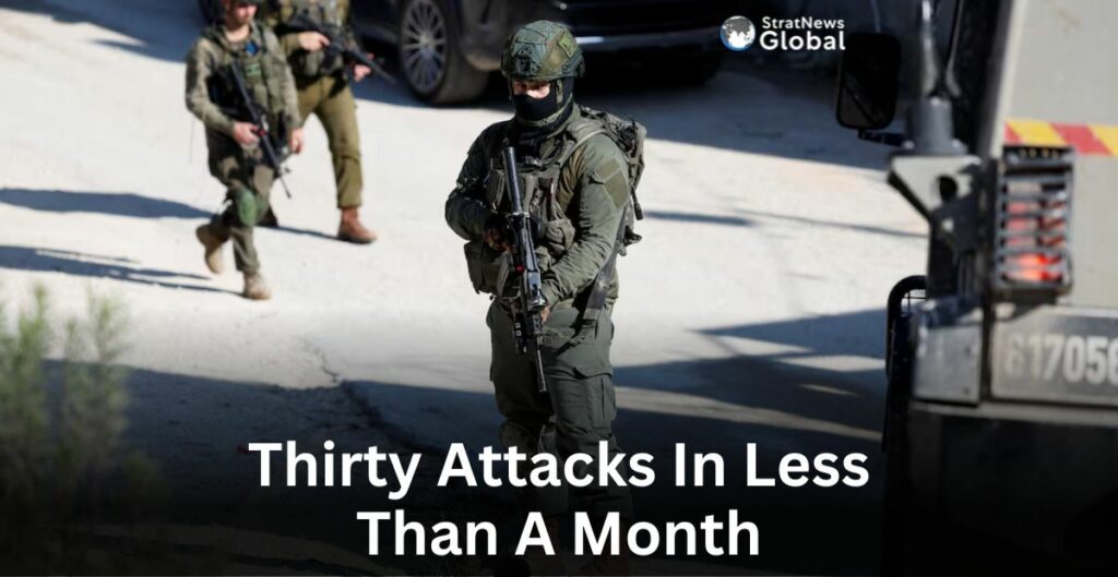 An Israeli soldier stands guard, after an Israeli settlers attack in Hawara in the Israeli-occupied West Bank.