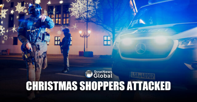 Members of police work at a Christmas market after a car drove into a group of people, in Germany