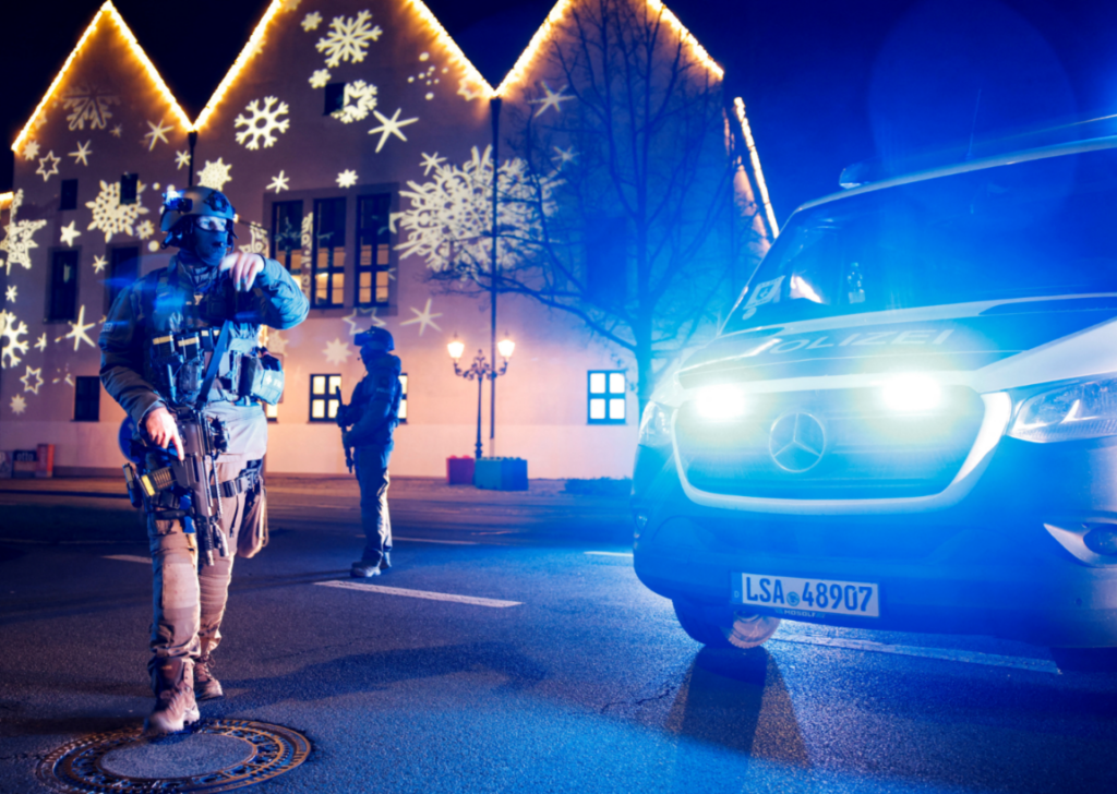 Members of police work at a Christmas market after a car drove into a group of people, in Germany
