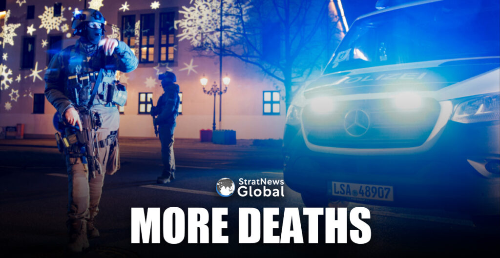 Members of police work at a Christmas market after a car drove into a group of people, in Germany