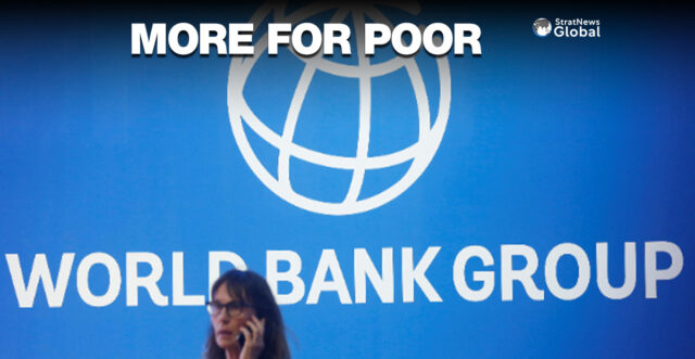 A participant stands near a logo of World Bank at the International Monetary Fund - World Bank Annual Meeting 2018 in Nusa Dua, Bali, Indonesia, October 12, 2018. REUTERS/Johannes P. Christo/File Photo