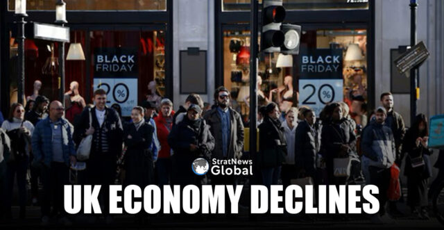 People stand near Black Friday signage in shop windows during Black Friday on Oxford Street in London, Britain, November 25, 2022. REUTERS/Henry Nicholls/File Photo