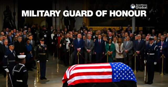 A military guard of honor stands next to the flag-draped casket of former US President Jimmy Carter at the US Capitol Rotunda