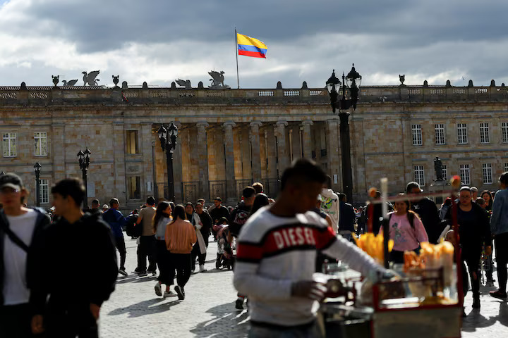 People walk at Plaza Bolivar on the day U.S. President Donald Trump announced to impose tariffs and sanctions after Colombian President Gustavo Petro refused to allow flights with deported Colombians to enter the country, in Bogota, Colombia January 26, 2025. REUTERS/Luisa Gonzalez