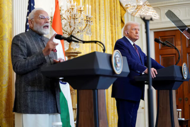JDTAFRTTJFKQ3K7JFE3NUSY4ZI U.S. President Donald Trump listens as Indian Prime Minister Narendra Modi speaks during a joint press conference at the White House in Washington, D.C., U.S., February 13, 2025. REUTERS/Nathan Howard
