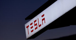 A view of Tesla logo at an electric vehicle charging station between Los Angeles and Las Vegas in Baker, California, U.S., November 19, 2024. REUTERS/Mike Blake/File Photo