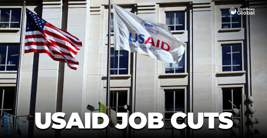 An American flag and USAID flag fly outside the USAID building in Washington, D.C., U.S., February 1, 2025. REUTERS/Annabelle Gordon/File Photo