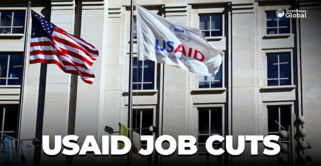 An American flag and USAID flag fly outside the USAID building in Washington, D.C., U.S., February 1, 2025. REUTERS/Annabelle Gordon/File Photo
