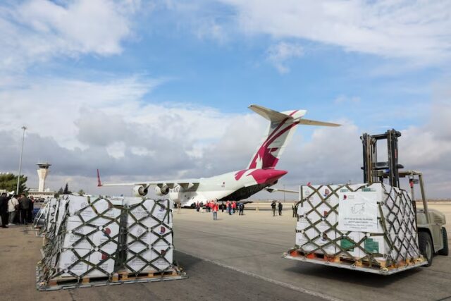VNZ55SSIYZNF3AZEUVHYAHV4RA People stand near a plane carrying aid from Qatar, as it arrives at Damascus International Airport, Syria, December 30, 2024. REUTERS/Yamam al Shaar/File Photo