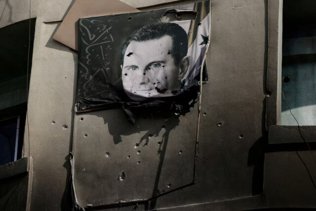 G2VW5DIAIZNAREKHSPYDR57WVQ A picture of Bashar al-Assad, damaged by bullets, hangs on the wall of a burnt building of Criminal Security department, after Syria's Bashar al-Assad was ousted, in Damascus, Syria, December 20, 2024. REUTERS/Zohra Bensemra/File Photo