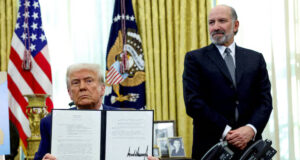 U.S. President Donald Trump holds an executive order about tariffs increase, flanked by U.S. Commerce Secretary Howard Lutnick, in the Oval Office of the White House in Washington, D.C., U.S., February 13, 2025. REUTERS/File Photo