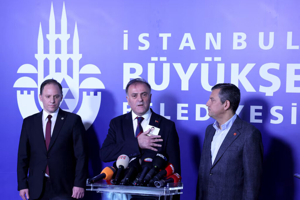 Acting Istanbul Mayor Nuri Aslan, accompanied by the main opposition Republican People's Party (CHP) leader Ozgur Ozel, speaks after a council elected an interim mayor to run the city, in Istanbul, Turkey, March 26, 2025. REUTERS/Dilara Senkaya