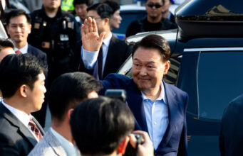 Ousted former South Korean President Yoon Suk Yeol waves to his supporters as he moves out of the presidential residence in Seoul, South Korea, April 11, 2025. Yonhap/via REUTERS/File Photo