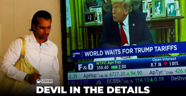 A man walks past a screen displaying U.S. President Donald Trump, at the Bombay Stock Exchange (BSE) ahead of Trump's tariff plans, in Mumbai, India, April 2, 2025. REUTERS/Francis Mascarenhas