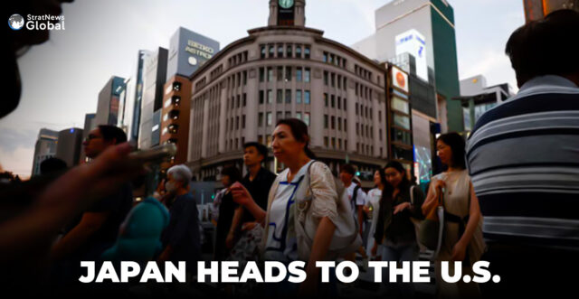 People cross the street at Ginza shopping district in Tokyo, Japan, August 11, 2024. REUTERS/Willy Kurniawan/File Photo