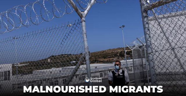 A private security employee stands guard during the inauguration of a closed-type migrant camp on the island of Samos, Greece, September 18, 2021. REUTERS/Alkis Konstantinidis/File Photo
