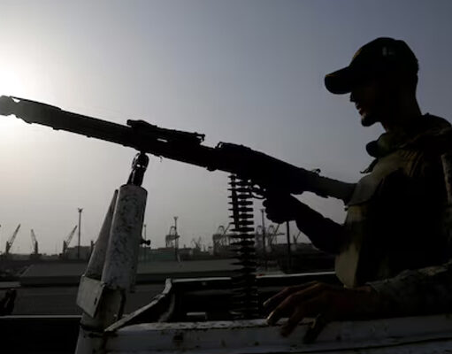 A paramilitary trooper mans a gun atop a vehicle as he keeps guard during a media tour of the Karachi Port, Pakistan, May 9, 2025. REUTERS/Shakil Adil