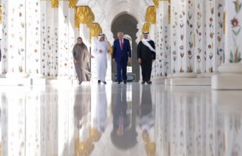 US President Donald Trump is reflected off the floor as he walks with Yousif Al Obaidli, director of Sheikh Zayed Grand Mosque and Ameena Al Hammadi, acting director of the Culture and Knowledge Department while visiting the Sheikh Zayed Grand Mosque in Abu Dhabi, UAE, May 15, 2025. REUTERS/Brian Snyder