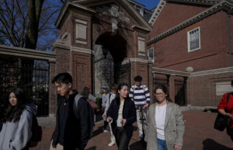 Students walk on the campus of Harvard University in Cambridge, Massachusetts, U.S., April 15, 2025. REUTERS/Faith Ninivaggi