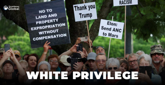 Demonstrators hold placards in support of U.S. President Donald Trump's stance against what he calls racist laws, land expropriation, and farm attacks, outside the American Embassy in Pretoria, South Africa, February 15, 2025. REUTERS/Siphiwe Sibeko/File Photo