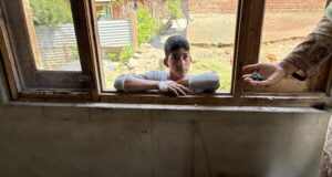 Villages On Line Of Control Struggle To Rebuild Lives After Pak Shelling Zubina Begum, 45, a housewife showing shrapnels that lie scattered in her bedroom as her son, a Class X student, looks on