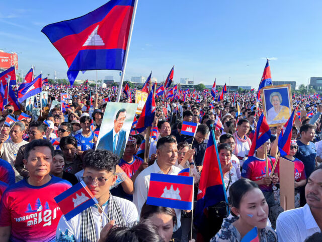 Y3WXF3MU7JMXJKEFRHGADUXVOI Cambodians hold national flags and a portrait of Cambodia's Hun Sen as they attend a