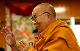 Tibetan spiritual leader, the Dalai Lama, offers blessings to his followers at his Himalayan residence in the northern hill town of Dharamshala, India, December 20, 2024. REUTERS/Priyanshu Singh/File Photo