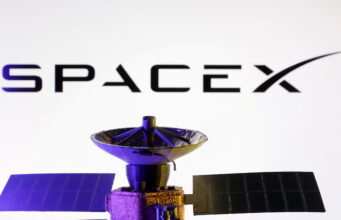 SpaceX logo and miniature satellite model are seen in this illustration taken, March 10, 2025. REUTERS/Dado Ruvic/Illustration/File Photo