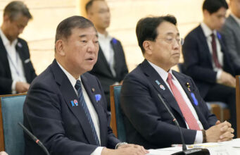 Japan's Prime Minister Shigeru Ishiba speaks next to Economic Revitalization Minister Ryosei Akazawa during a meeting with cabinet ministers to discuss Japan's strategy in dealing with U.S. tariffs, at Ishiba's official residence in Tokyo, Japan July 8, 2025, in this photo taken by Kyodo. Kyodo/via REUTERS/File Photo
