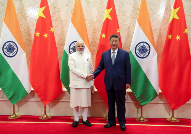 India's PM Modi shakes hands with Chinese President Xi Jinping during a meeting in Tianjin