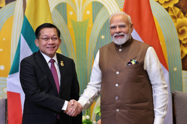 India's PM Modi shakes hands with Myanmar's military chief Min Aung Hlaing during a meeting in Tianjin