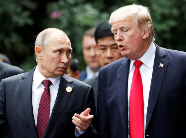 4M4KMWJ5XZJIXI2EHR6OUP3Y5M U.S. President Donald Trump and Russia's President Vladimir Putin talk during the family photo session at the APEC Summit in Danang, Vietnam November 11, 2017. REUTERS/Jorge Silva/File Photo
