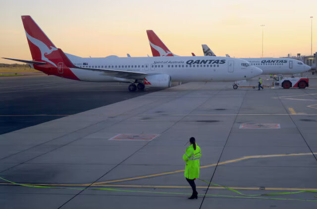 EHMW6VO5IRMH5KZNQJ7ZPSKM4I Workers can be seen near Qantas Airways, Australia's national carrier, Boeing 737-800 aircraft on the tarmac at Adelaide Airport, Australia, August 22, 2018. REUTERS/David Gray/File Photo