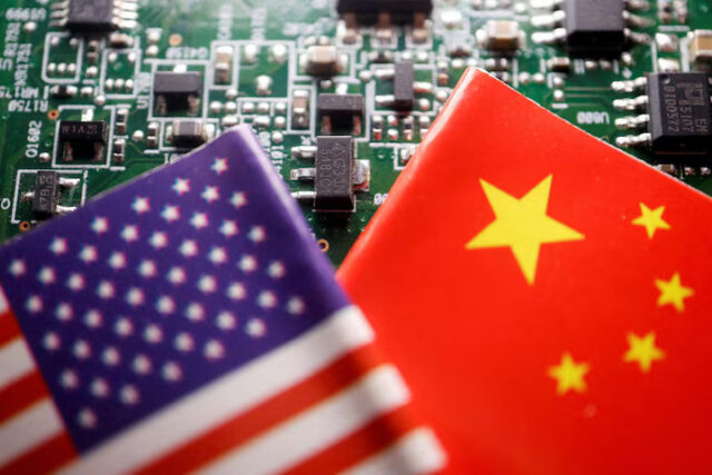 HYUNACXJ5FKUFCCYF4TTFPSGO4 Flags of China and U.S. are displayed on a printed circuit board with semiconductor chips, in this illustration picture taken February 17, 2023. REUTERS/Florence Lo/Illustration