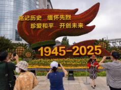 China Plans Grand Military Parade To Mark 80 Years Of Japan’s Surrender People take images of a flower installation commemorating the 80th anniversary of the end of World War Two, in Beijing, China, August 18, 2025. REUTERS/Maxim Shemetov