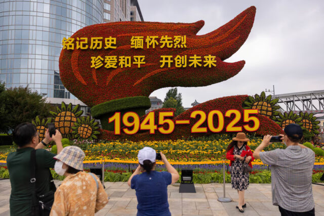 KZTDA6V5TZPFXAKS7LWVFZFHNU People take images of a flower installation commemorating the 80th anniversary of the end of World War Two, in Beijing, China, August 18, 2025. REUTERS/Maxim Shemetov