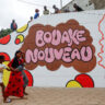 Residents of Bouake walk past a painted wall, one day ahead of Ivory Coast 65th independence anniversary day in Bouake, Ivory Coast August 6, 2025. The painting on the wall reads "New Bouake" REUTERS/Luc Gnago/File Photo