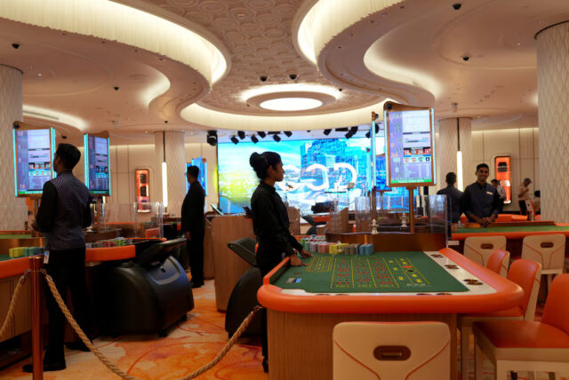 RU6TFIXH2ZJAPEK73BIKZS4PXU Employees stand inside a casino at City of Dreams, an integrated resort that includes Sri Lanka's first high end casino, in Colombo, Sri Lanka, August 25, 2025.