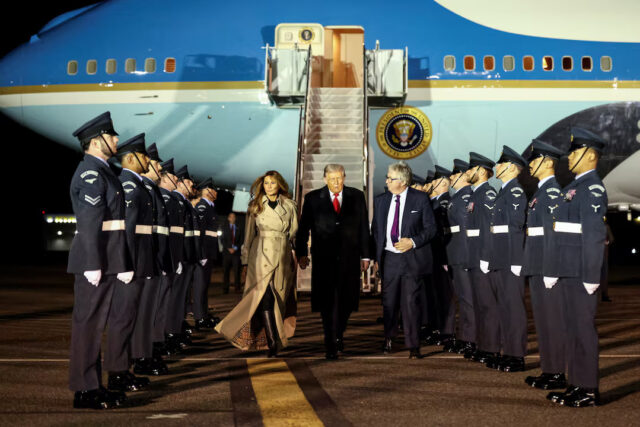 5OBI4DBS4ZLURNUJ5ACLBTI3IA U.S. President Donald Trump walks with first lady Melania Trump and Viscount Henry Hood upon arrival at London Stansted Airport for a state visit to Britain, near London, Britain, September 16, 2025. REUTERS/Kevin Lamarque