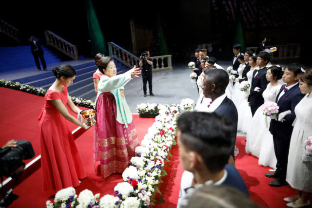 A3YSCLKATRJQFGCANGWDJPD6XE Han Hak-ja, widow of Evangelist Reverend Moon Sun-myung, sprays holy water to bless couples during a mass wedding ceremony of the Unification Church at Cheongshim Peace World Centre in Gapyeong, South Korea, August 27, 2018. REUTERS/Kim Hong-Ji/File Photo