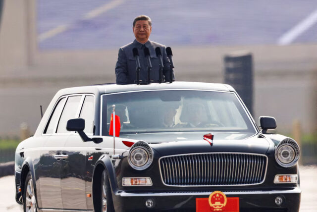 SPFPHYKXJZJKFP3TF4KNQPSLHQ Chinese President Xi Jinping stands in a car to review the troops during a military parade to mark the 80th anniversary of the end of World War Two, in Beijing, China, September 3, 2025. REUTERS/Tingshu Wang