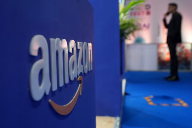 KVQ45PGAZJKWZK26E6H5LXWDZY A visitor stands near a logo of Amazon during the annual Retail Leadership Summit in Mumbai, India, February 27, 2025. REUTERS/Hemanshi Kamani