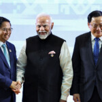 Prime Minister Narendra Modi shakes hands with Vietnam's Prime Minister Pham Minh Chinh alongside Laos' Prime Minister Sonexay Siphandone during the 21st ASEAN-India Summit at the National Convention Centre, in Vientiane, Laos. REUTERS/Athit Perawongmetha