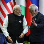 Prime Minister Narendra Modi speaks with Prime Minister of Timor-Leste Xanana Gusmao during the 21st ASEAN-India Summit at the National Convention Centre, in Vientiane, Laos. REUTERS/Athit Perawongmetha