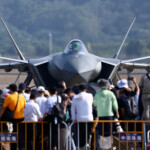 Visitors stand in front of a J-20 fighter jet at the China International Aviation and Aerospace Exhibition, or Airshow China, in Zhuhai, Guangdong province, China November 12, 2024. REUTERS/Tingshu Wang