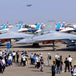 Visitors stand in front of J-15 fighter jets of the Chinese People's Liberation Army (PLA) Navy at the China International Aviation and Aerospace Exhibition, or Airshow China, in Zhuhai, Guangdong province, China November 12, 2024. REUTERS/Tingshu Wang