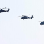 Z-10, Z-20 and Z-8 helicopters fly in the sky at the China International Aviation and Aerospace Exhibition, or Airshow China, in Zhuhai, Guangdong province, China November 12, 2024. REUTERS/Tingshu Wang