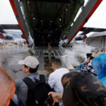 People visit a Y-20 transport aircraft displayed at the China International Aviation and Aerospace Exhibition, or Airshow China, in Zhuhai, Guangdong province, China November 14, 2024. REUTERS/Tingshu Wang